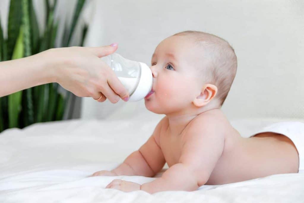 baby drinking formula from bottle