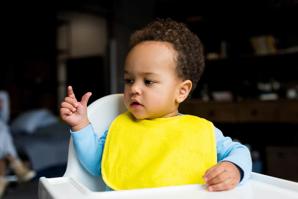 Baby boy wearing a yellow bib