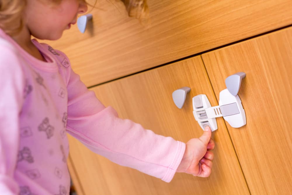 Best Drawer And Cabinet Locks 2022 Keep Curiosity Out LittleOneMag   Baby Girl Trying To Open A Kitchen Cabinet 