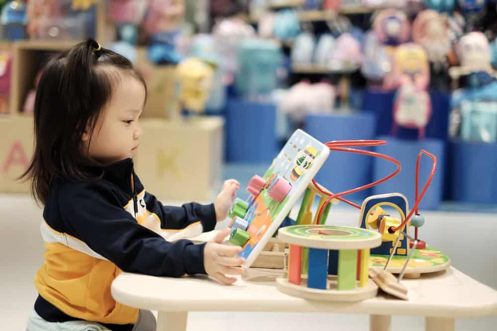 Child playing with toys on a table