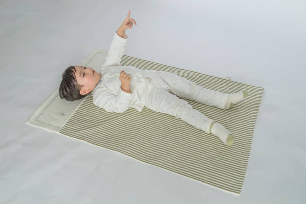 Toddler resting on a nap mat