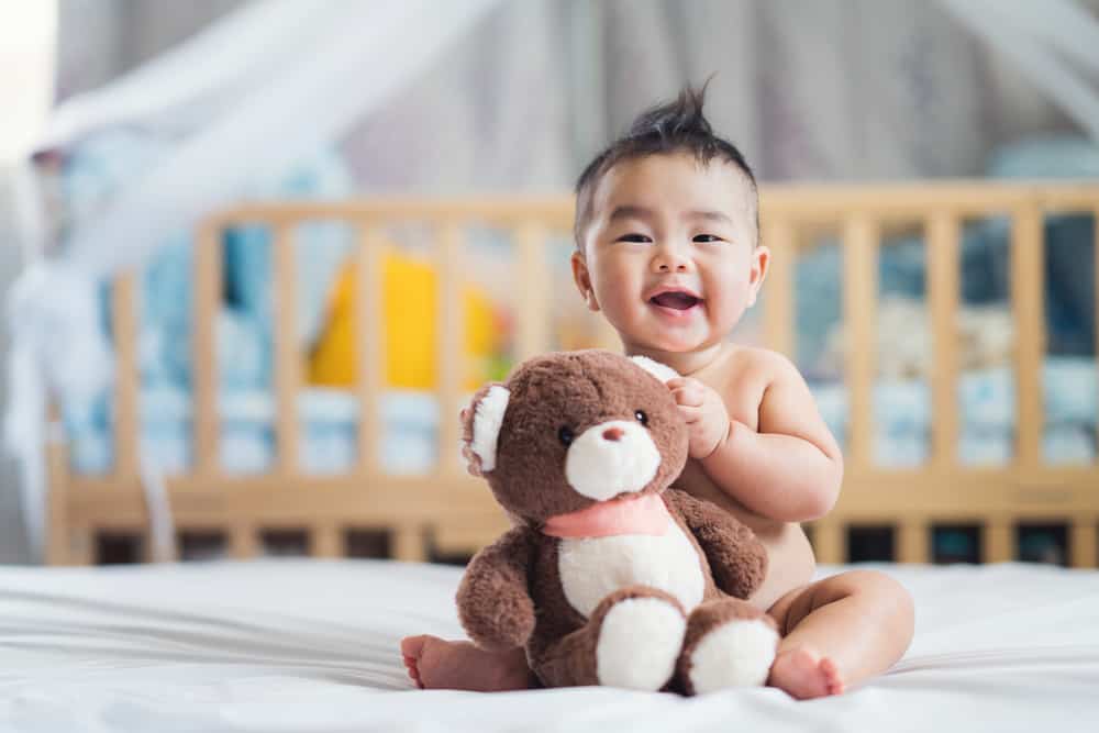 baby holding a teddy bear