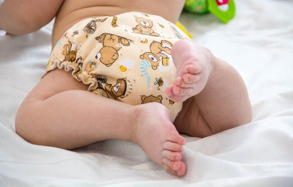 close up of baby wearing teddy bear diapers