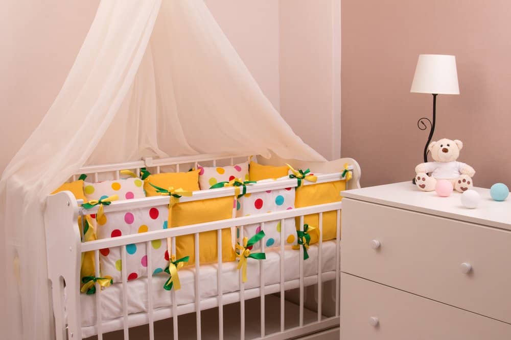 crib with multicolored bumpers