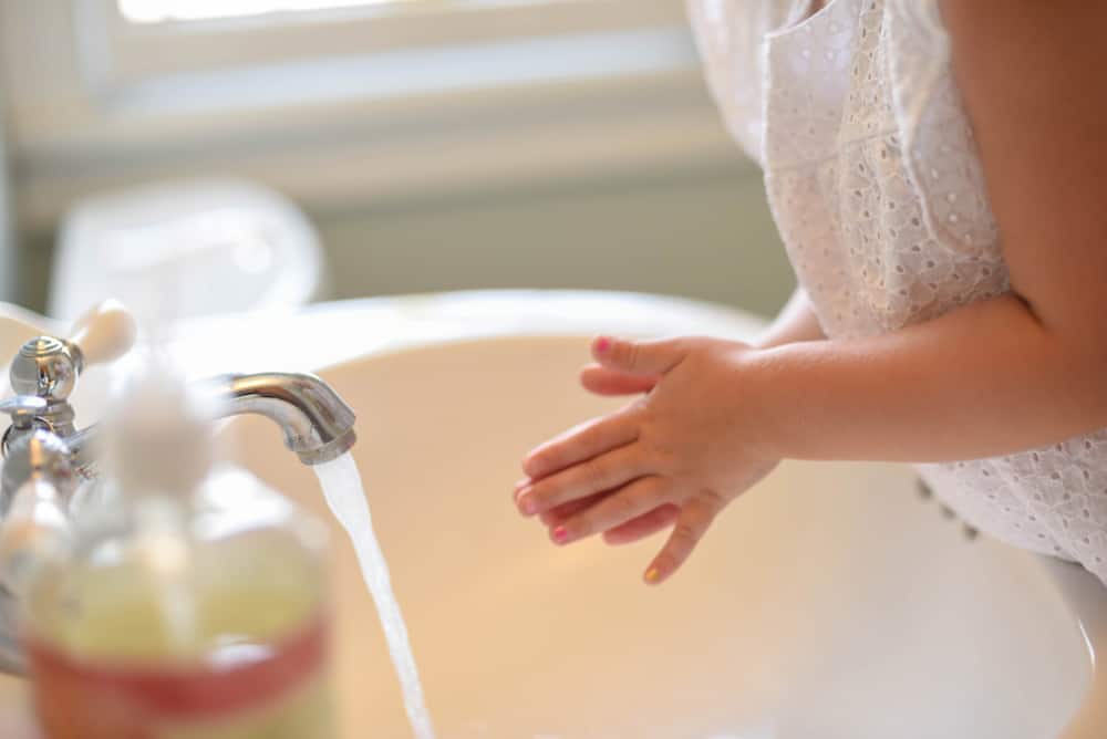 little girl washing her hands