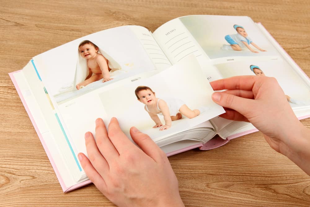 placing baby pictures in memory book