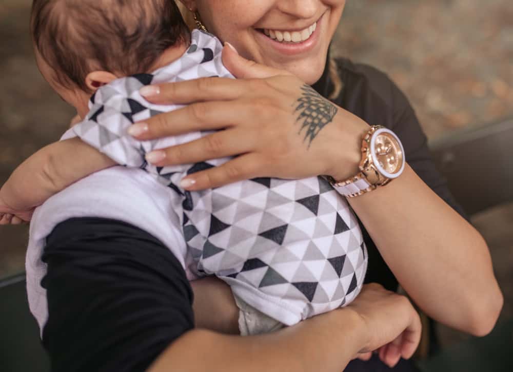 mom burping baby over her shoulder