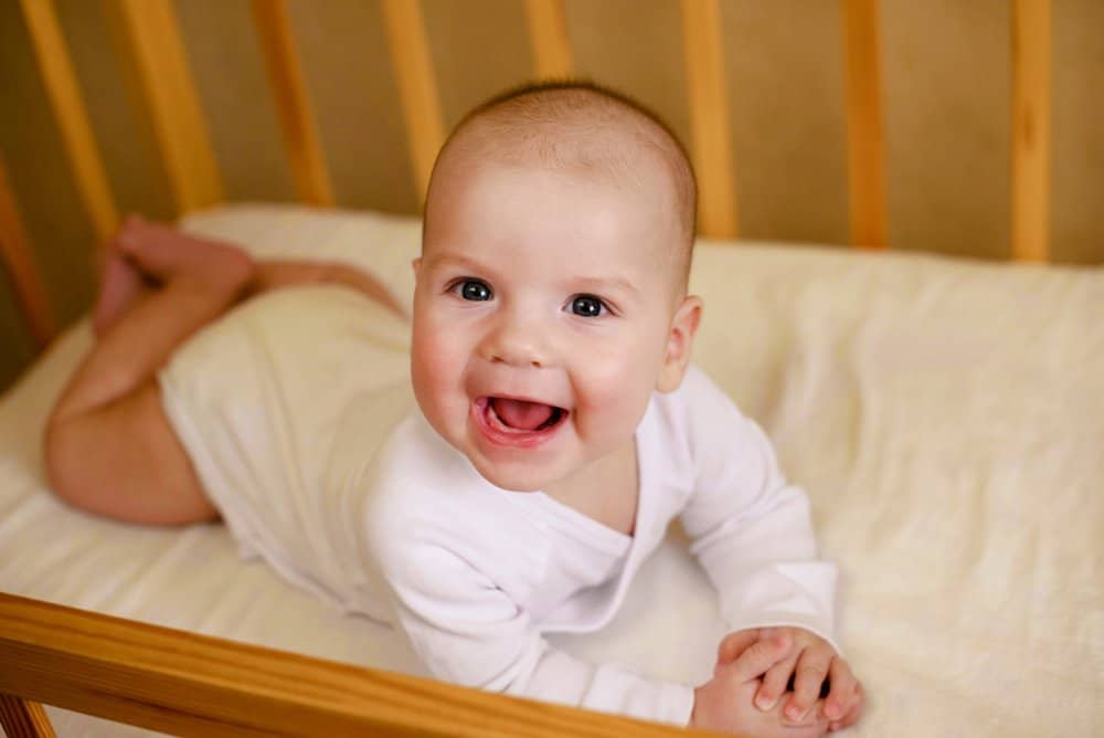 happy baby in crib
