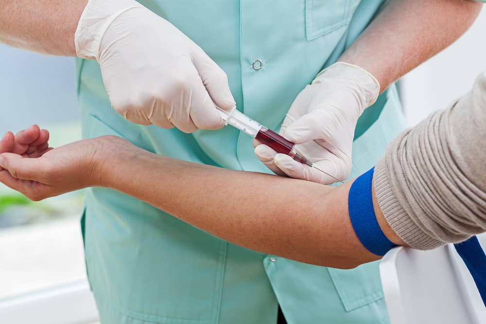 a nurse performing a blood test on a woman