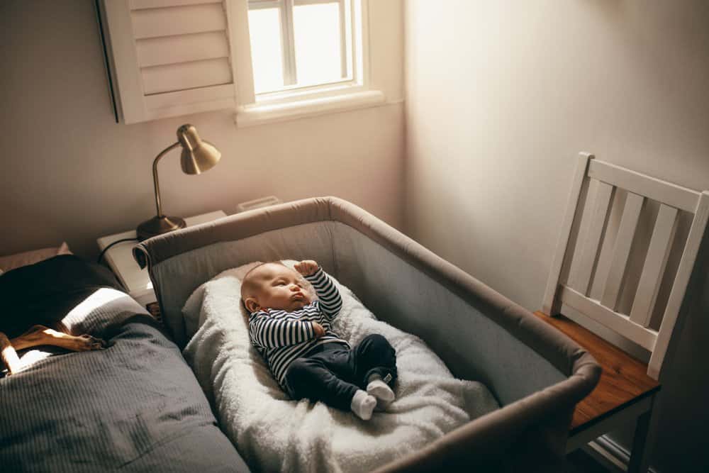 baby in bassinet by bed