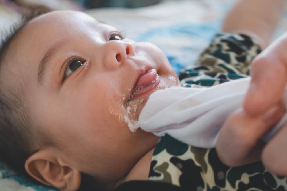 cute baby smiling while spitting up