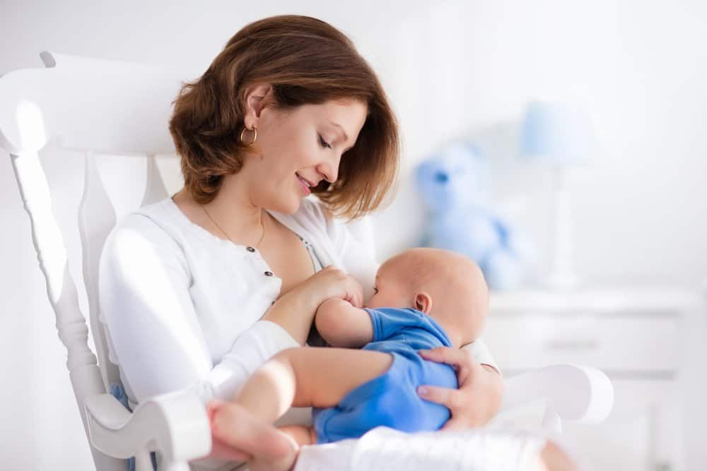 mother breastfeeding baby upright