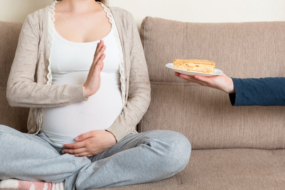 pregnant woman saying no to food