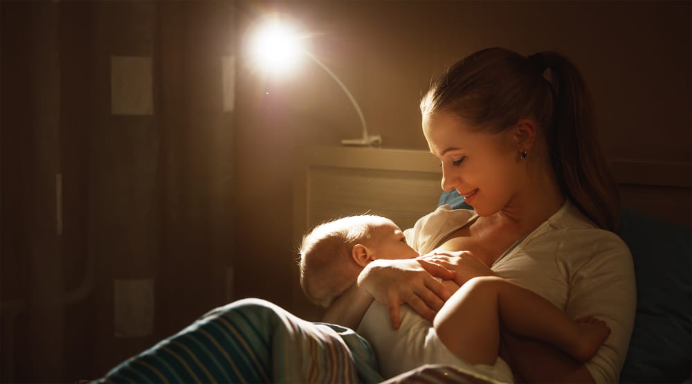 mom breastfeeding baby at night