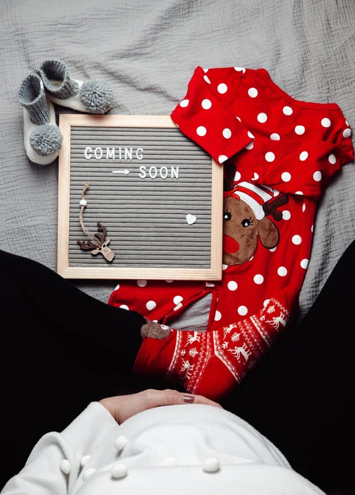 pregnancy announcement with Christmas onesie