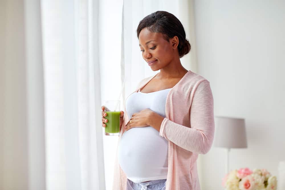 pregnant woman drinking juice