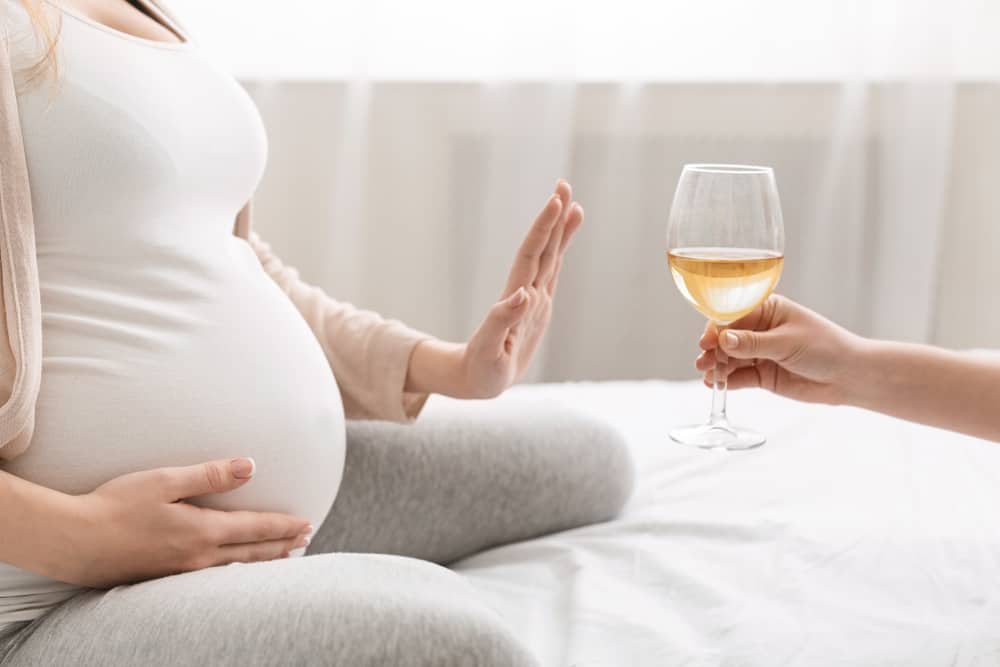 pregnant woman refusing wine