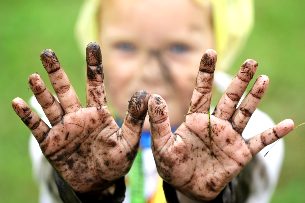 kid with muddy hands