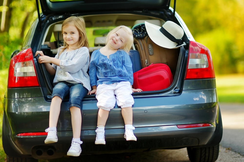 sisters sat in car boot